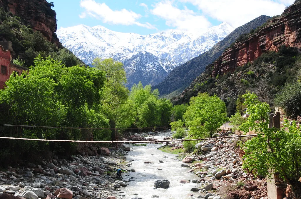 Ourika gorge canyon walls framing a distant snow-capped Atlas peak Ourika gorge canyon walls framing a distant snow-capped Atlas peak