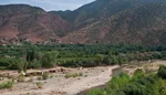 Asni Valley village nestled among orchards below red High Atlas foothills