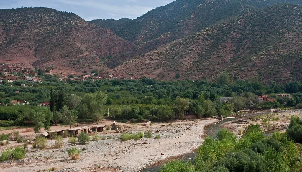 Asni Valley village nestled among orchards below red High Atlas foothills Asni Valley village nestled among orchards below red High Atlas foothills