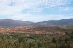 View across the Asni Valley toward layered red High Atlas foothills