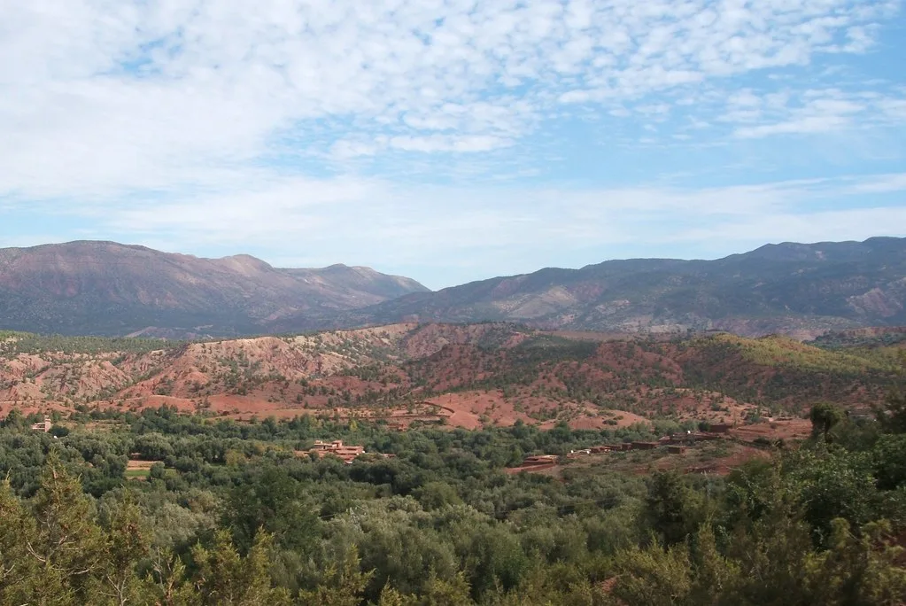 View across the Asni Valley toward layered red High Atlas foothills View across the Asni Valley toward layered red High Atlas foothills